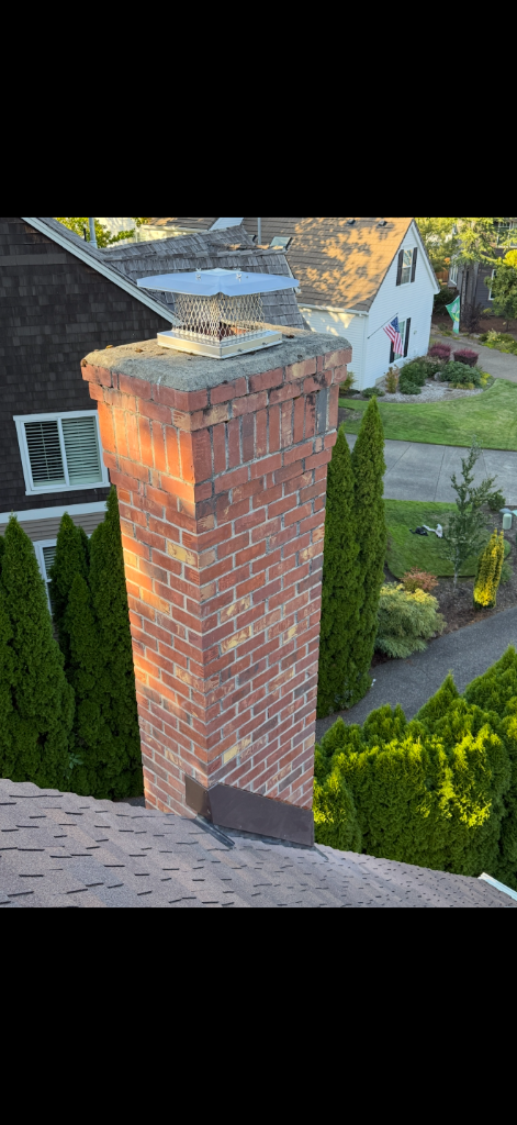 Brick chimney with cap by DNT Masonry