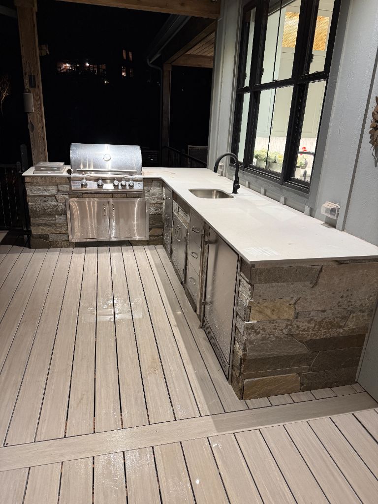 Custom outdoor kitchen with stone base by DNT Masonry