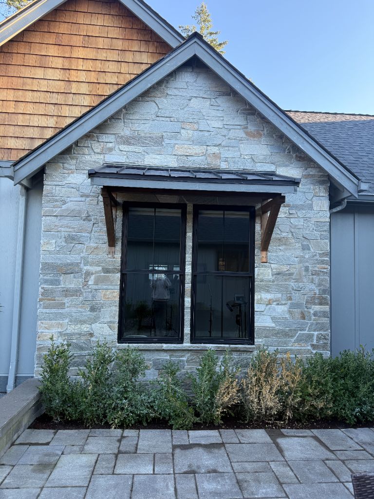 Natural stone facade with window surround by DNT Masonry